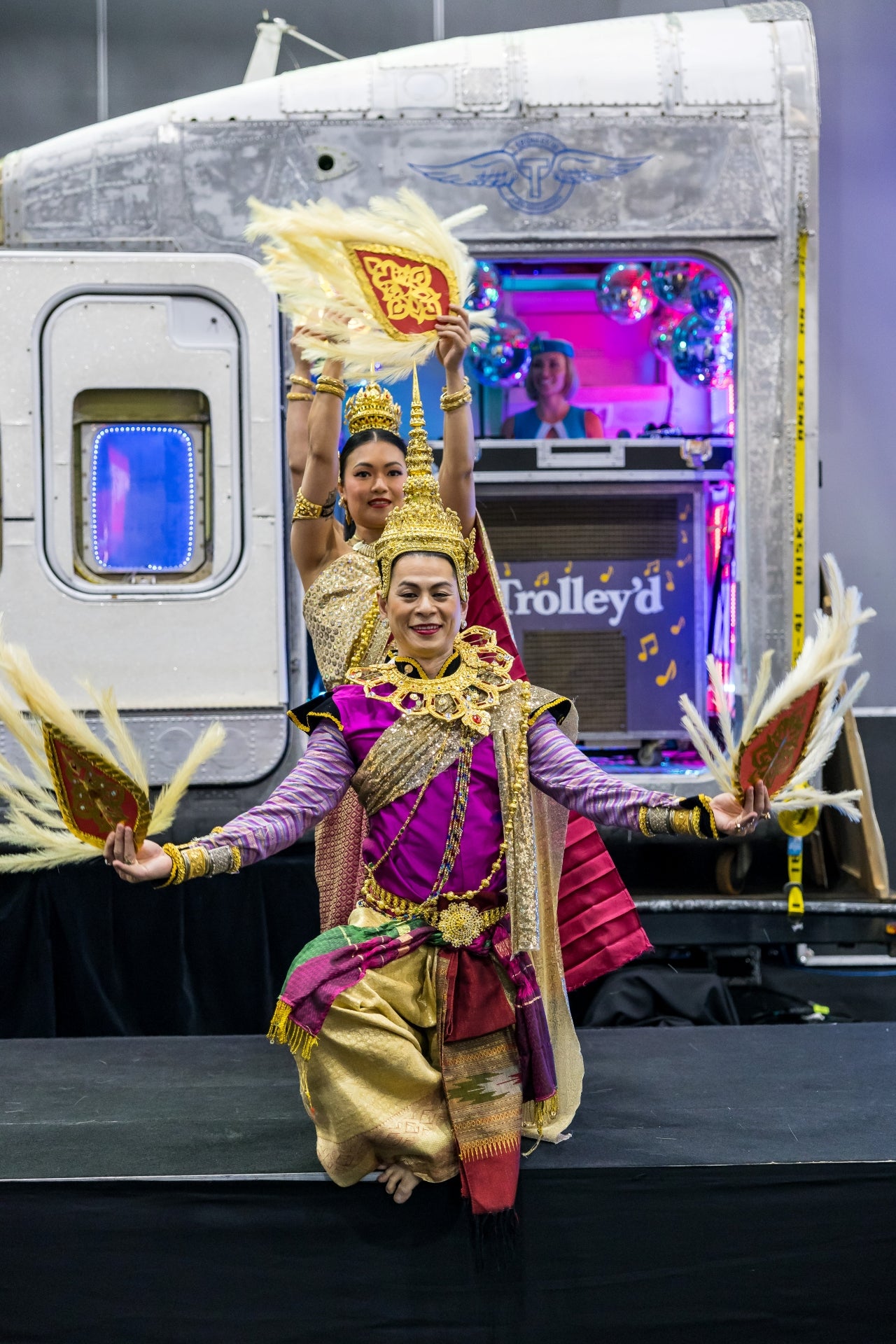 Traditional cultural dancers performing in front of Trolley’d aircraft cockpit installation at AIME 2026 Hosted Buyer Lounge Melbourne