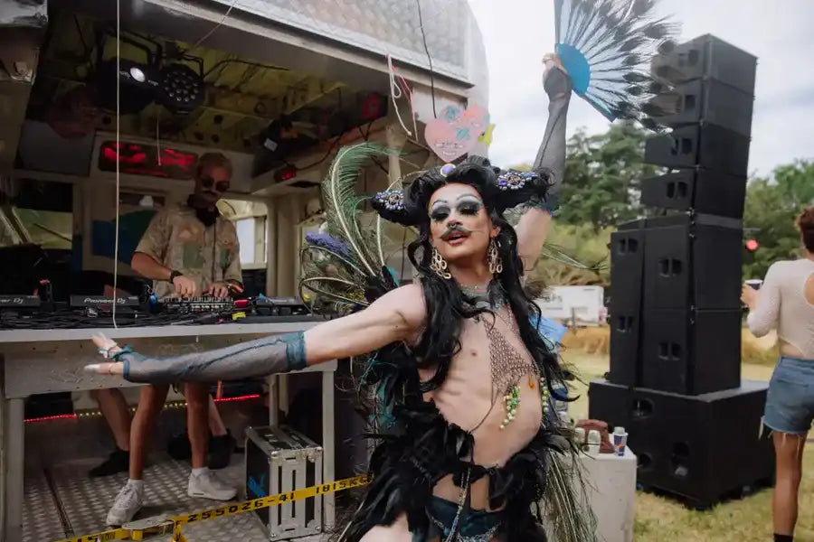 A black feathered costume with intricate metallic embellishments and a dramatic, theatrical design.