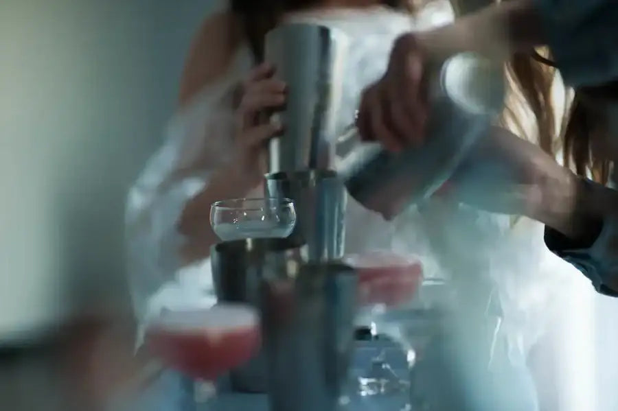 A sleek, metallic cocktail shaker with a polished finish and sturdy handle.