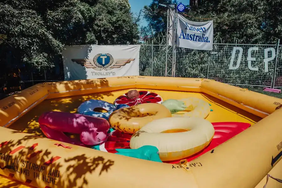 Yellow inflatable pool with colorful floating rings inside