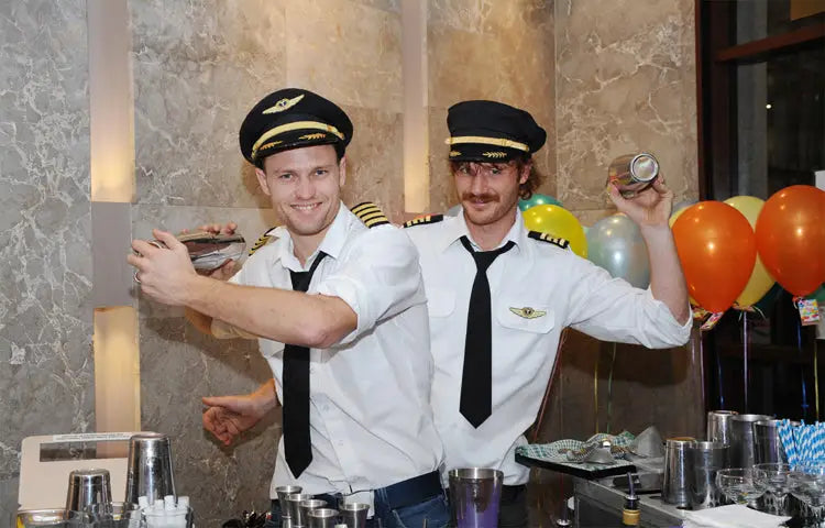 2 pilot bartenders from Trolley'd mixing up first class cocktails from an airline trolley that has been converted into a cool looking bar.