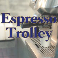 Espresso machine brewing coffee into a white cup on an espresso trolley with locally roasted beans.