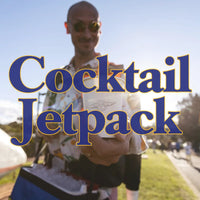 A Trolley'd bartender wearing a jetpack and holding a drink, with the text "Cocktail Jetpack" overlayed, showcasing the unique mobile bartending service at an outdoor event.