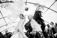 Two people dancing at Wild Ducks wedding, one in a wedding dress, other in feathered costume.