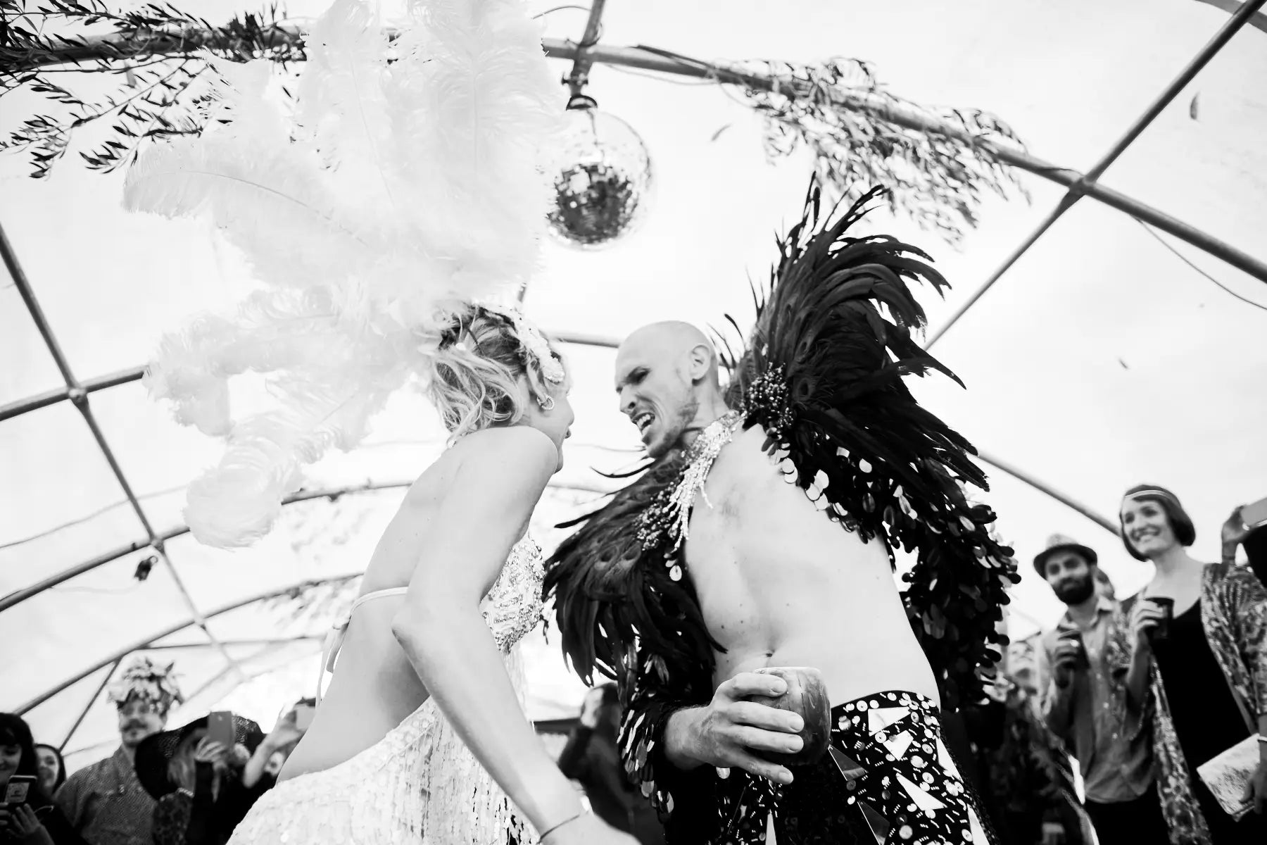 Two people dancing at Wild Ducks wedding, one in a wedding dress, other in feathered costume.