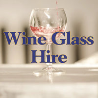 A promotional image for Trolley'd Wine Glass Hire service featuring a close-up of red wine being poured into an elegant wine glass with the text "Wine Glass Hire" overlaid.