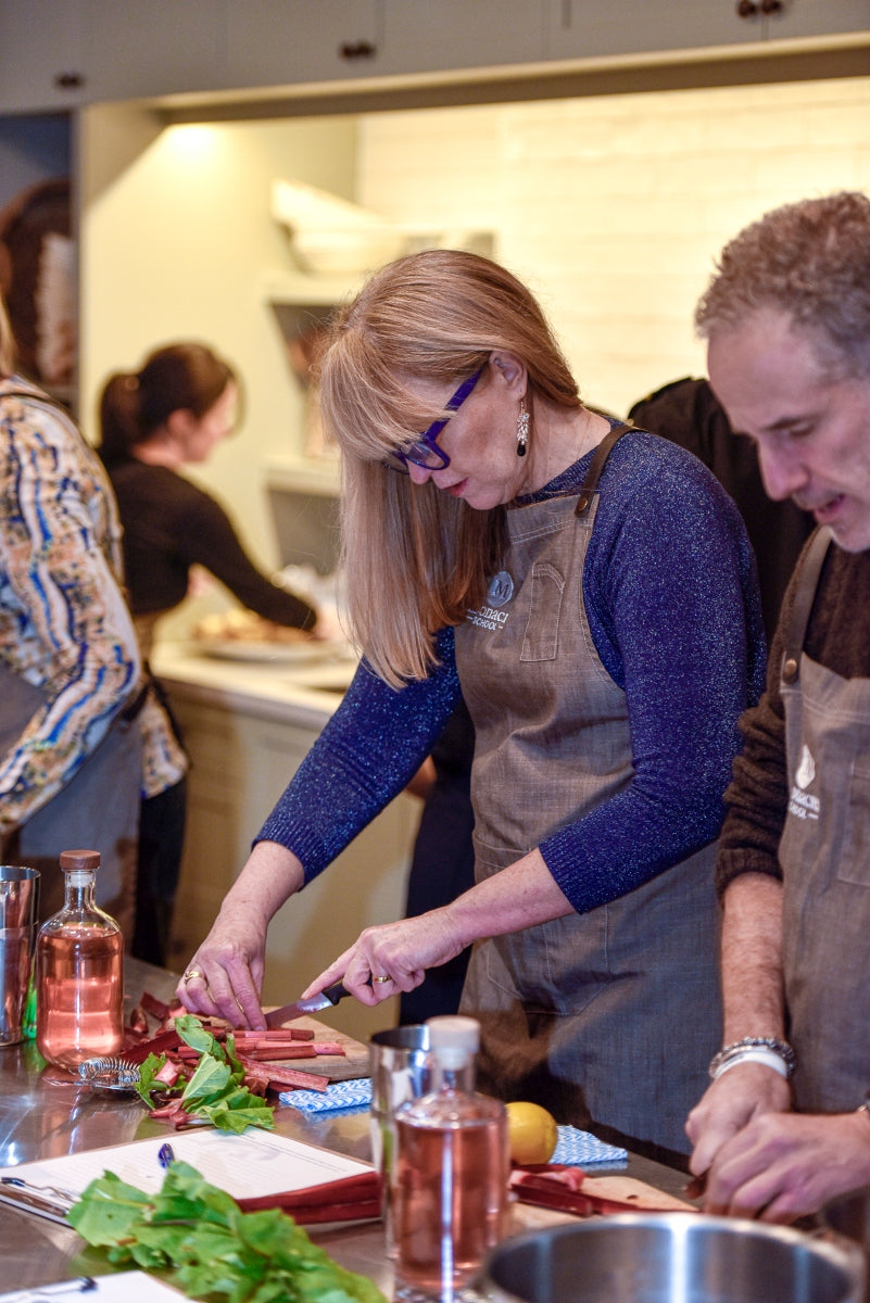 Guests preparing Moonacres farm rhubarb at a shared workbench during Kindred Cocktails