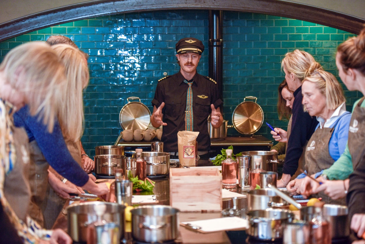 Byron Woolfrey guiding guests at a preparation bench during Kindred Cocktails at Moonacres School