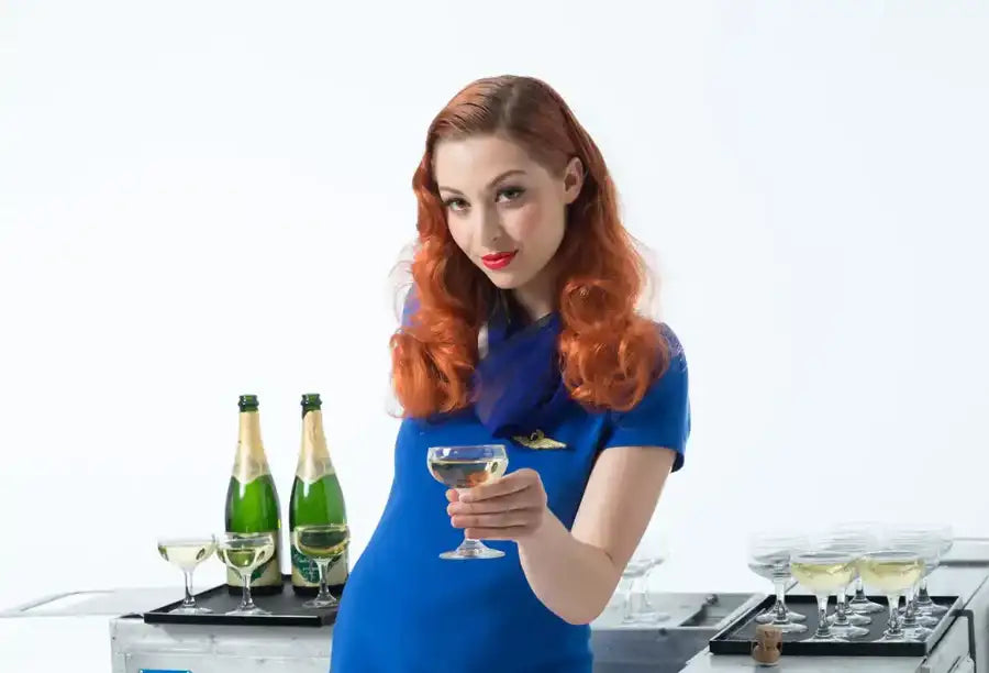 Blue flight attendant uniform with gold pin on left chest