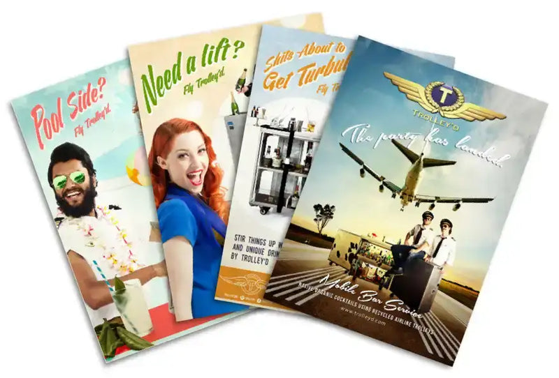Four colorful, glossy promotional brochures for trolley’s cocktail bar series featuring vibrant images of people and airplanes with bold text.