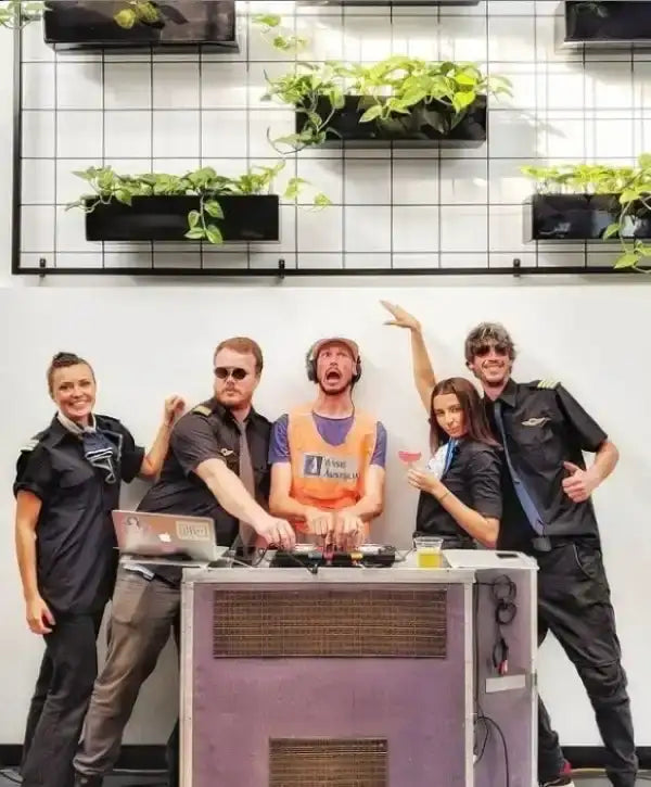 Purple speaker with a metal grille and ventilation slats.