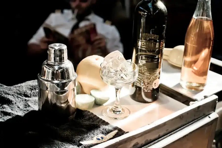 Shiny silver cocktail shaker with a polished metallic finish and classic tiered design.