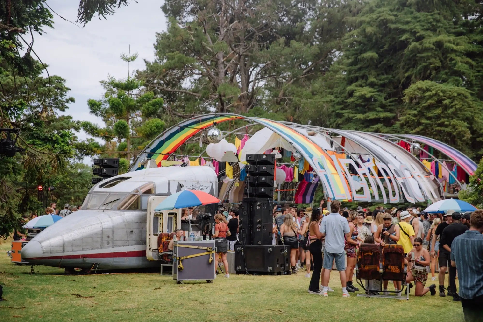 Silver and red model train locomotive with a sleek, aerodynamic design parked outdoors.