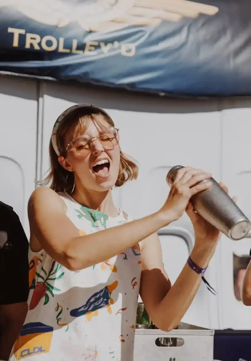 A stainless steel cocktail shaker with a brushed metallic finish and a slightly tapered cylindrical shape.