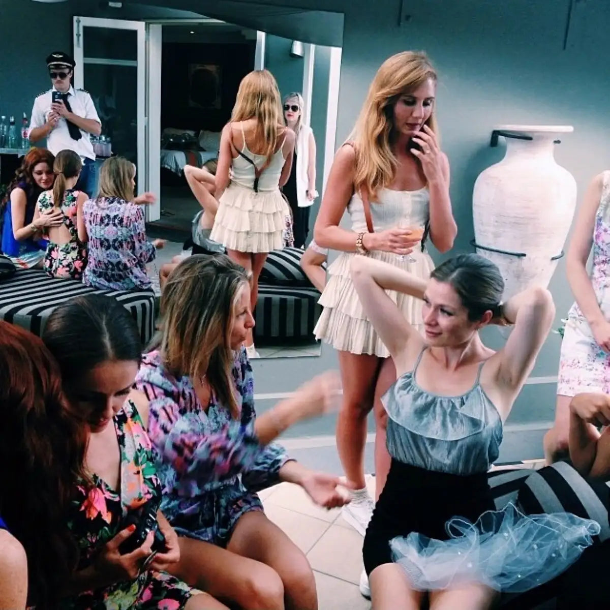 A woman wearing a light blue ruffled top and black shorts with a sheer tulle skirt.