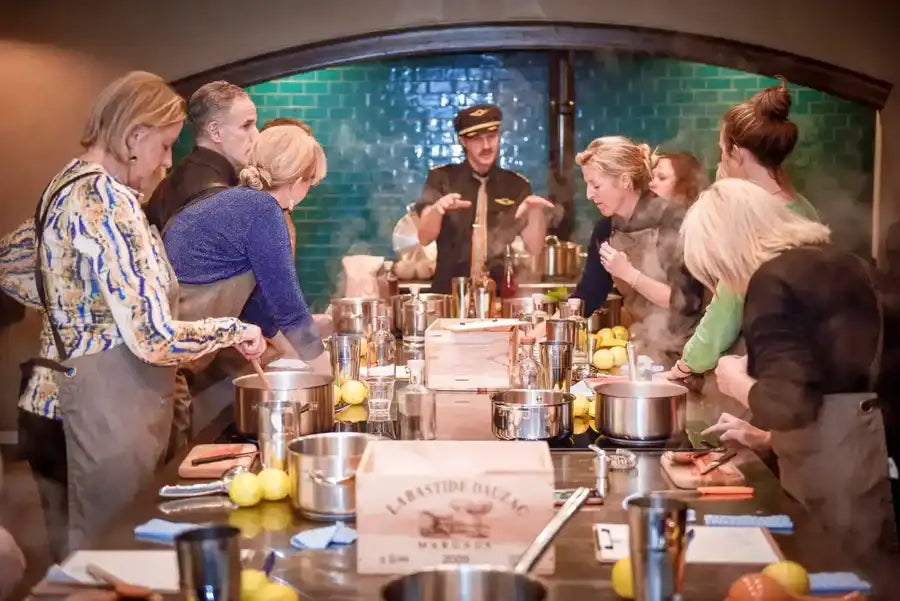 A wooden box with a white label reading ’larastide béc’ and the word ’morseur,’ placed on a countertop among cooking utensils.